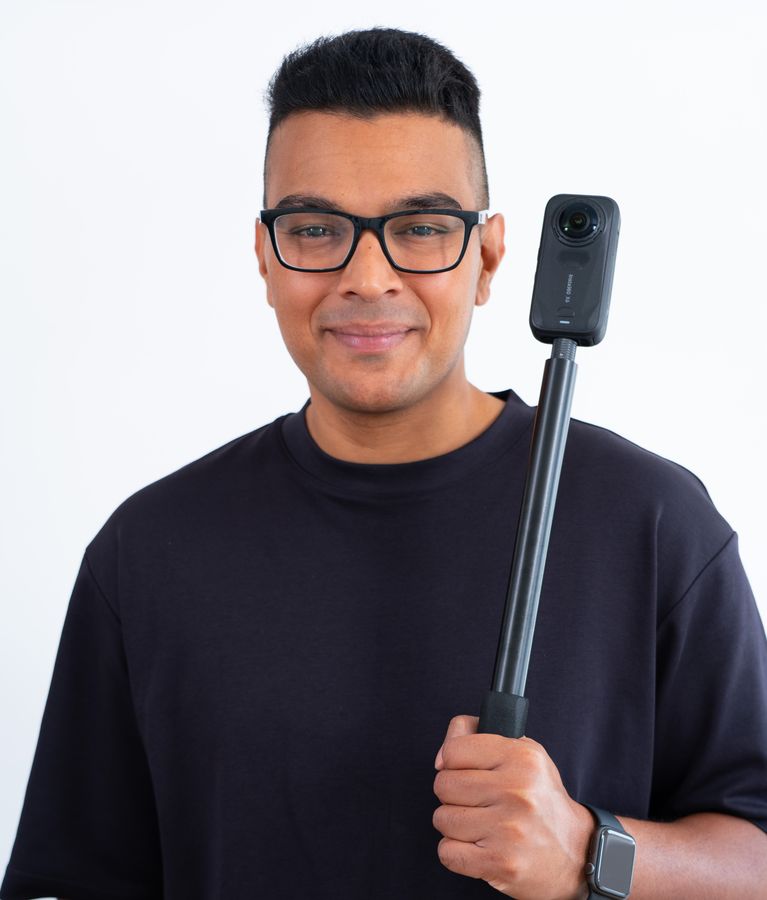 Shanil Kawol holding an Insta360 camera on a selfie stick